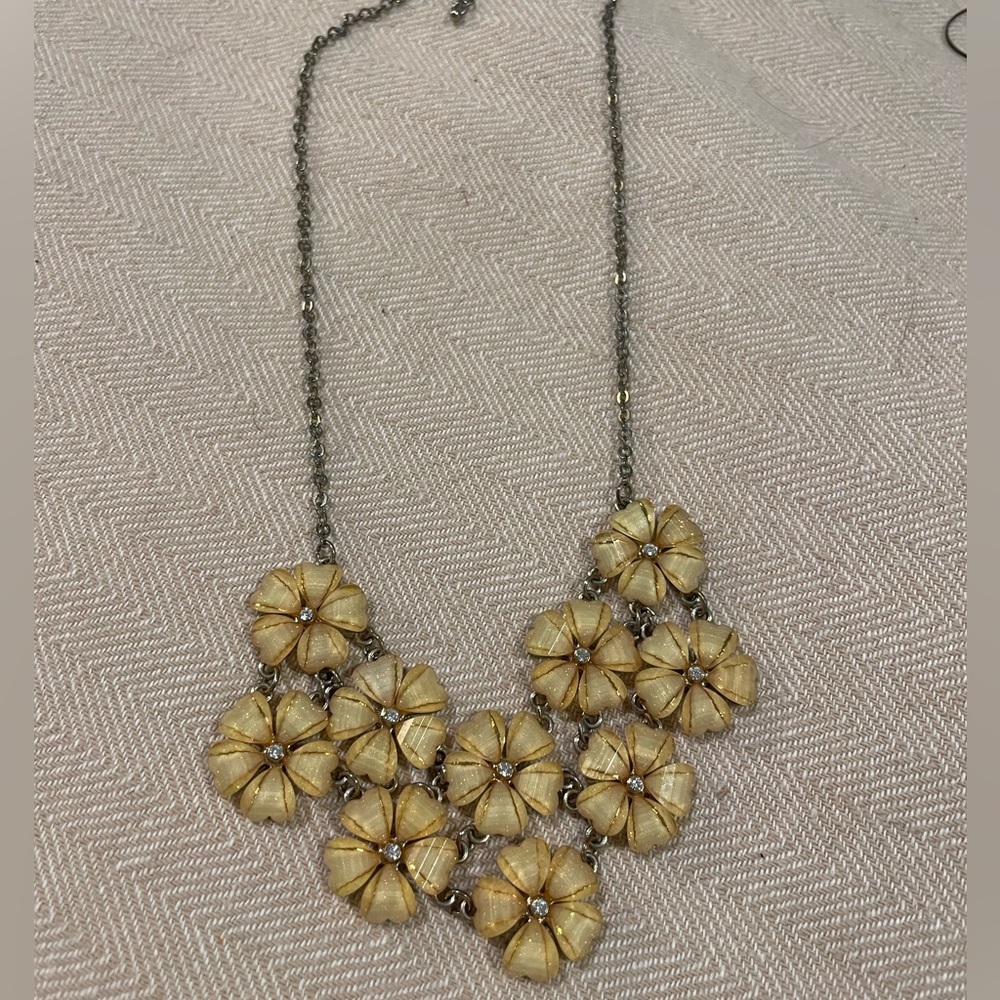 Costume jewelry necklace. Silver with diamonds and pale pink/light tan flowers.